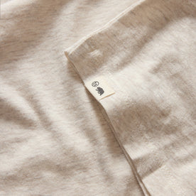 material shot of the hem and TS label on The Cotton Hemp Long Sleeve Tee in Heathered Oat, Knits by Taylor Stitch