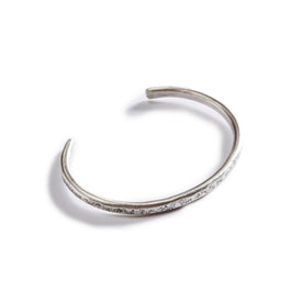 flatlay of The Hammered Cuff in Silver, from the top, Accessories by Taylor Stitch