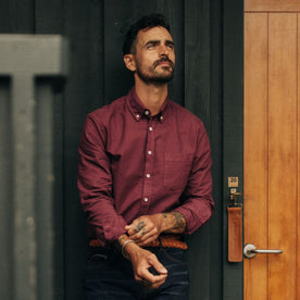 fit model adjusting his sleeves in The Jack in Burgundy Oxford, Wovens by Taylor Stitch