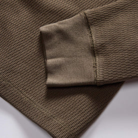 material shot of the ribbed cuffs on The Organic Cotton Waffle Crew in Fatigue Olive, Knits by Taylor Stitch