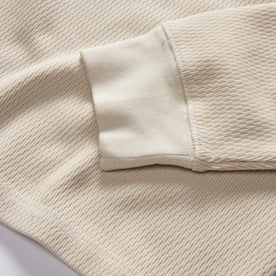 material shot of the ribbed cuffs on The Organic Cotton Waffle Crew in Natural, Knits by Taylor Stitch