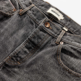 material shot of the button fly on The Slim Jean in Black 1-Year Wash Selvage Denim, closed, Bottoms by Taylor Stitch