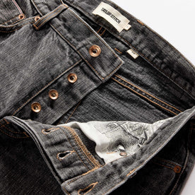 material shot of the button fly on The Slim Jean in Black 1-Year Wash Selvage Denim, Bottoms by Taylor Stitch