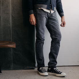 fit model standing in The Slim Jean in Black 1-Year Wash Selvage Denim, Bottoms by Taylor Stitch