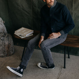 fit model on a bench in The Slim Jean in Black 1-Year Wash Selvage Denim, Bottoms by Taylor Stitch