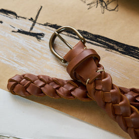 editorial image of the buckle of The Braided Belt in Whiskey on a piece of paper, Accessories by Taylor Stitch