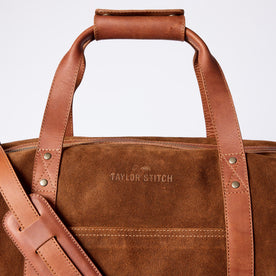 material shot of the leather handles and strap on The Weekender Duffle in Chocolate Roughout, Accessories by Taylor Stitch