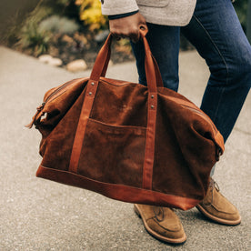 fit model carrying The Weekender Duffle in Chocolate Roughout, Accessories by Taylor Stitch