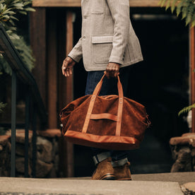 fit model with The Weekender Duffle in Chocolate Roughout, Accessories by Taylor Stitch