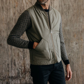 fit model with his hand in the pocket of The Workhorse Vest in Stone Boss Duck, Outerwear by Taylor Stitch