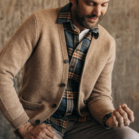 fit model sitting in The Eddy Cardigan in Camel Herringbone Merino, Knits by Taylor Stitch