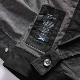 material shot of the Halley Stevensons label on The Long Haul Jacket in Coal Waxed Canvas, Outerwear by Taylor Stitch