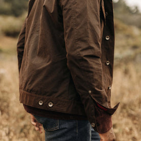 fit model showing off hem and cuff on The Long Haul Jacket in Dark Khaki Waxed Canvas, Outerwear by Taylor Stitch