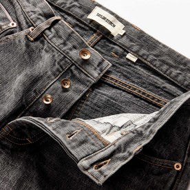 material shot of the button fly on The Democratic Jean in Black 1-Year Wash Selvage Denim, Bottoms by Taylor Stitch