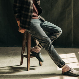 fit model sitting in The Democratic Jean in Black 1-Year Wash Selvage Denim, Bottoms by Taylor Stitch