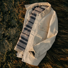 flatlay of The Workhorse Utility Jacket in Light Khaki Chipped Canvas on the grass, Outerwear by Taylor Stitch