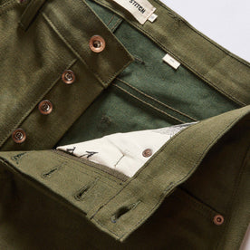 material shot of the button fly on The Slim Jean in Olive Nihon Menpu Selvage, Bottoms by Taylor Stitch