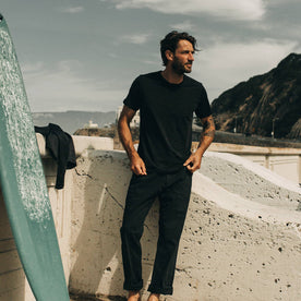 fit model standing wearing The Merino Tee in Heather Black, Knits by Taylor Stitch