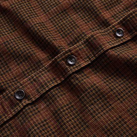 material shot of the buttons on The Saddler Shirt in Dark Roast Plaid Cord, Wovens by Taylor Stitch