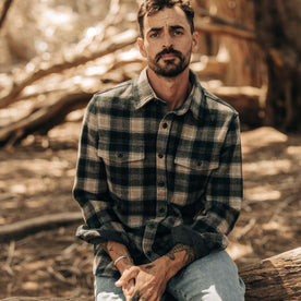 fit model sitting in The Maritime Shirt Jacket in Dried Pine Plaid, Wovens by Taylor Stitch