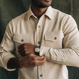 fit model buttoning the cuffs on The Point Shirt in Natural Sashiko, Wovens by Taylor Stitch