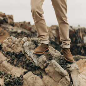 fit model on rocks in The Ranch Boot in Golden Brown Waxed Suede, Footwear by Taylor Stitch