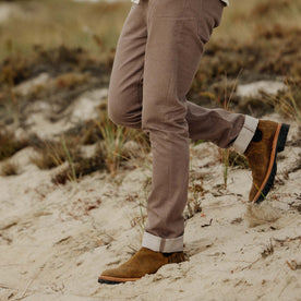 fit model walking on a log in The Slim All Day Pant in Silt Broken Twill, Bottoms by Taylor Stitch