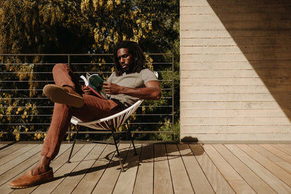 Model sitting on a chair in The Après Pant