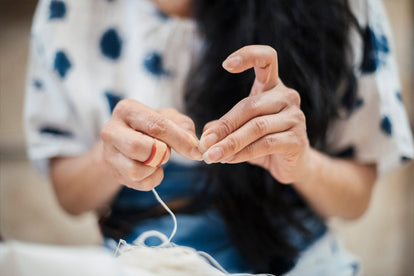 Teresa in the process of sewing fabric