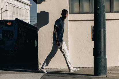 Model walking in The Slim Jean in Natural Selvage