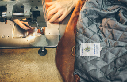 Leather being sewn for our Moto Jacket.