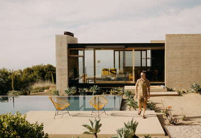 Model walking by the pool in the Short Sleeve Davis Shirt and Apres Short in Tarnished Gold