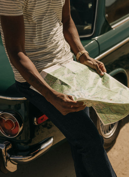 Model looking at a map of the desert