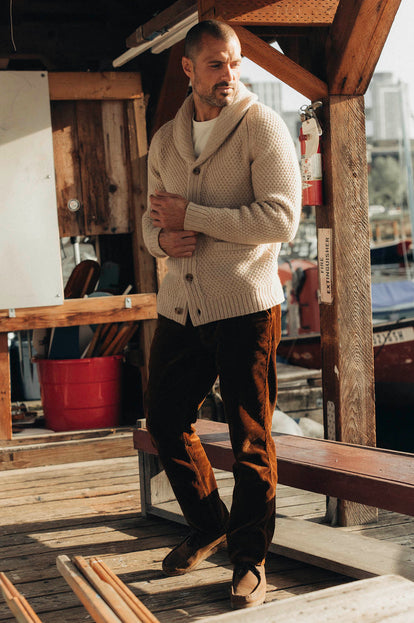 Model adjusting the sleeves on The Fisherman Shawl Cardigan