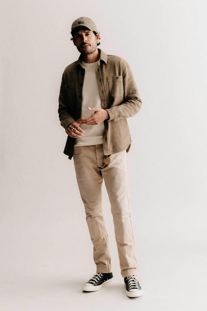 Model wearing The Pathfinder Cap in Fatigue Olive and Dry and the Utility Shirt in Cypress Sashiko