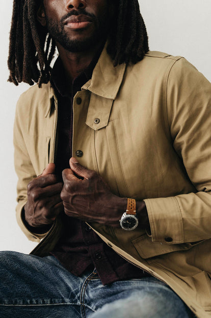 Model adjusting The Pathfinder Jacket in Khaki Dry Wax