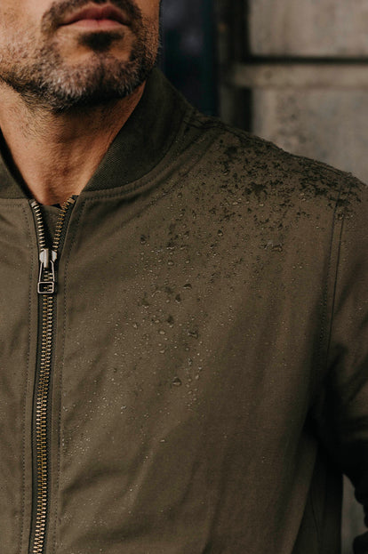 Water droplets on the sureace of our Bomber Jacket in Fatigue Olive Dry Wax