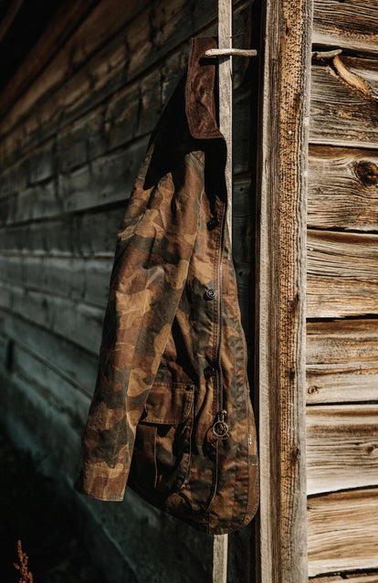 The Field Jacket in Camo hanging on a door