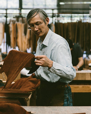 Inspecting raw materials at Golden Bear sportswear factory, one of our indutry partners