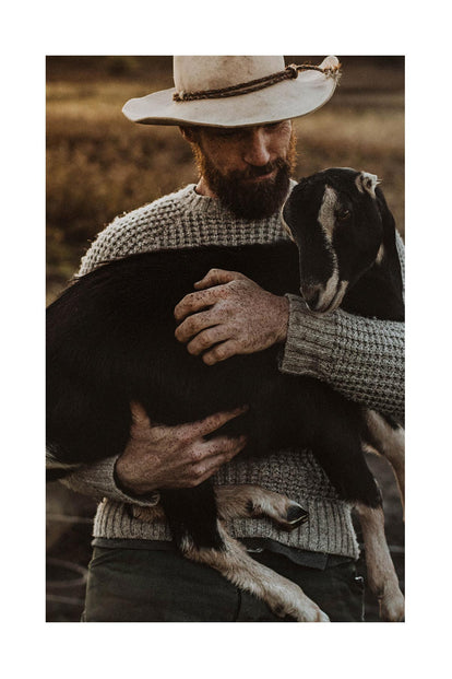 Josh holding a goat.