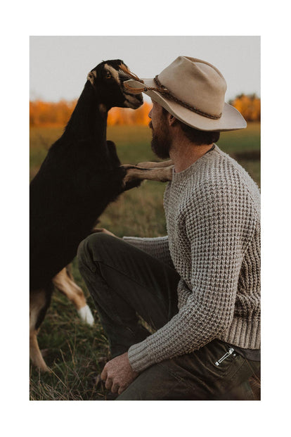 Josh playing with a goat.