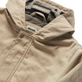 material shot of the hood and button closure of The Workhorse Hoodie in Sand Boss Duck, Outerwear by Taylor Stitch