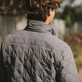 The fit model showing us the back of the vertical jacket in ash, Outerwear by Taylor Stitch