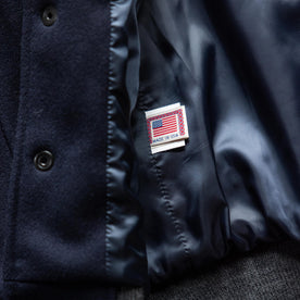 material shot of the made in USA label on The Golden Bear Snap Bomber in Midnight Wool, Outerwear by Taylor Stitch