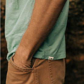 fit model posing with his hands in his pockets wearing The Cotton Hemp Tee in Teal, Knits by Taylor Stitch