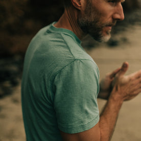 fit model walking on the beach in The Cotton Hemp Tee in Teal, Knits by Taylor Stitch