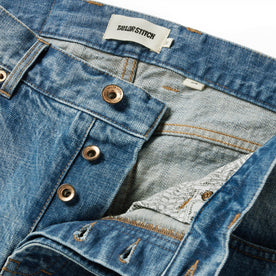 material shot of the button closures on The Slim Jean in Patch Wash Selvage, Bottoms by Taylor Stitch