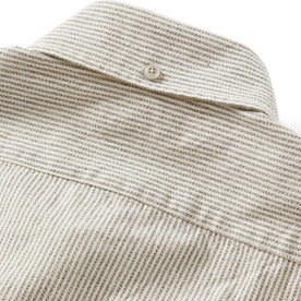 material shot of the button on the back collar of The Jack in Coal Jaspe University Stripe Oxford, Wovens by Taylor Stitch