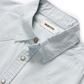 material shot of the brass button and collar on The Western Shirt in Bleached Indigo Stripe, Wovens by Taylor Stitch