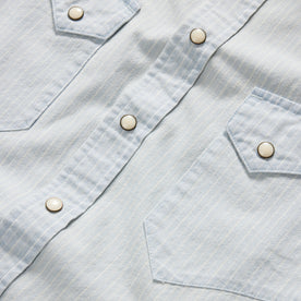 material shot of the buttons and dual chest pockets on The Western Shirt in Bleached Indigo Stripe, Wovens by Taylor Stitch